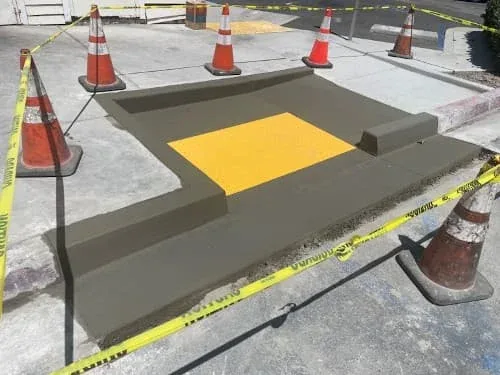 New concrete ADA ramp area with yellow detectable warning surface under construction
