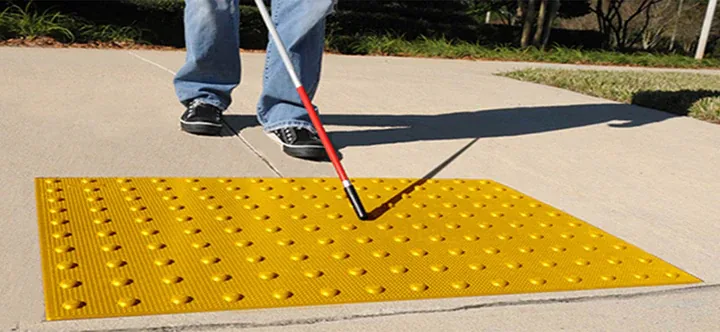 Yellow truncated dome detectable warning panel on a concrete walkway