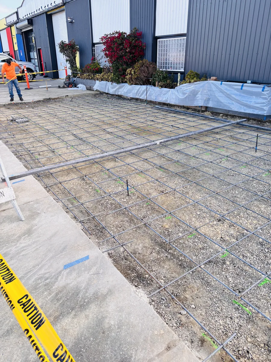 Concrete flatwork area prepared with compacted base and reinforcing steel before placement