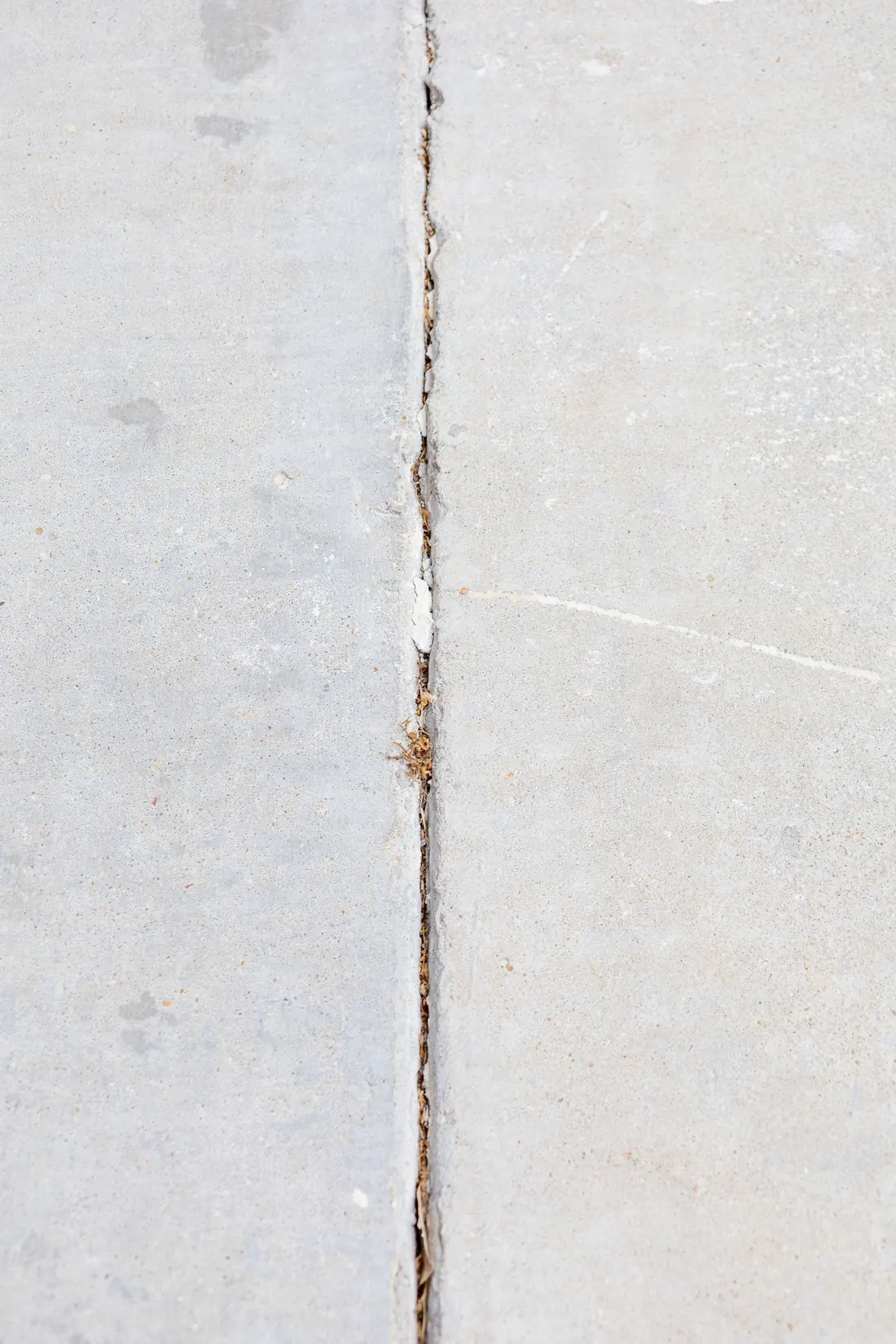 Concrete sidewalk displacement and trip hazard near a commercial property
