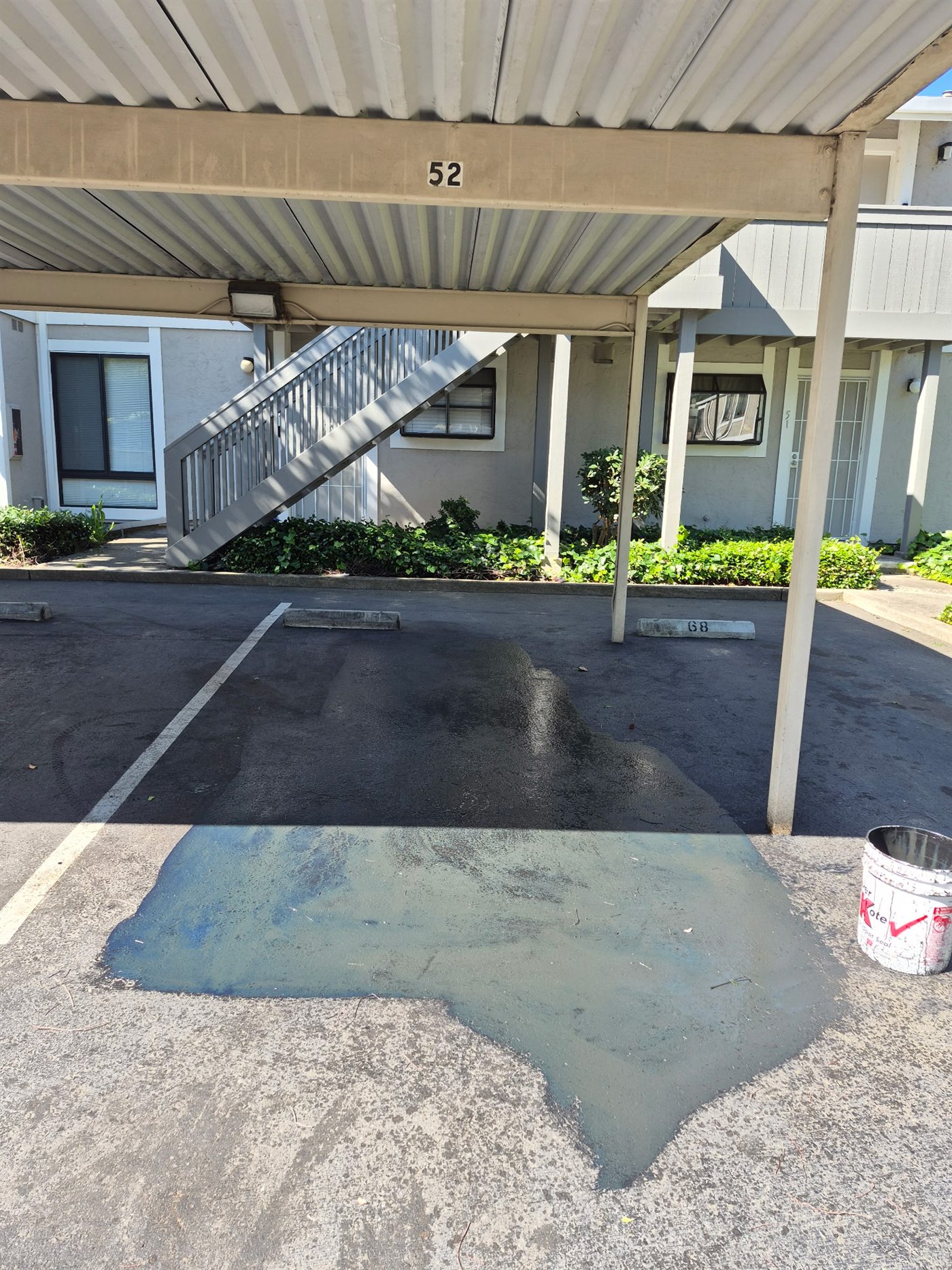 Oil spot treatment applied to a parking area before sealcoating